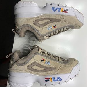 Women’s Filas size 6 1/2. Worn once. In great condition with one defect.